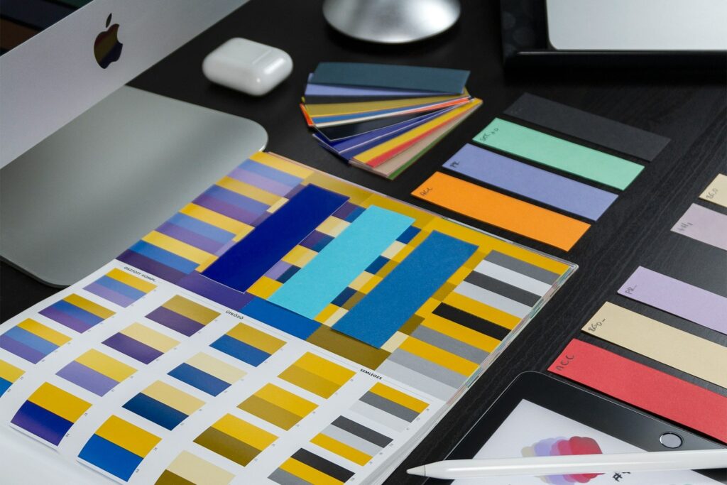 Colorful paint and design palettes on a desk, demonstarting trade dress elements and representation in Trade Dress litigation by Lapple Ubell IP Law in Irvine, California.
